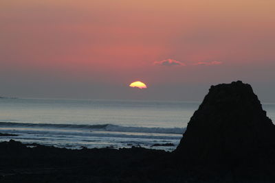 Scenic view of sea against sky at sunset