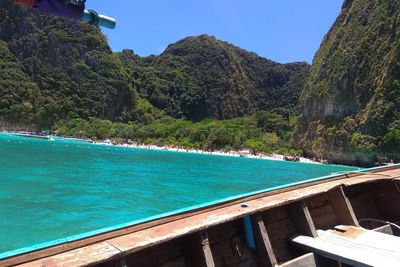 Scenic view of sea and mountains against clear blue sky