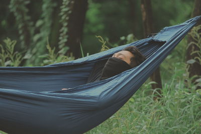 Man relaxing in hammock