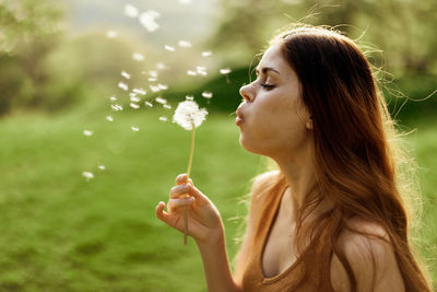 Young woman blowing bubbles