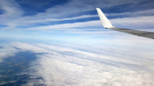 Cropped image of airplane flying in sky