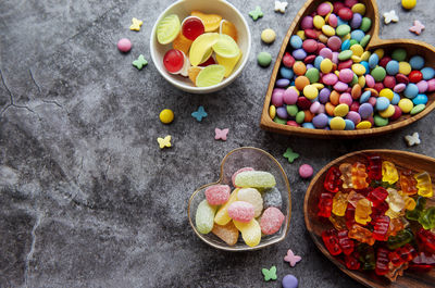 Multicolored candies, dragees and jelly on a black background