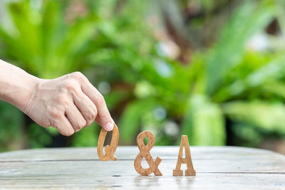 Close-up of person holding ice cream on table