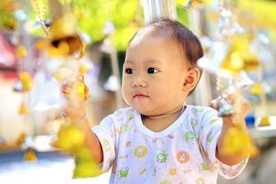 Cute girl playing with bells outdoors