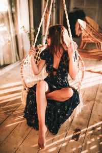 Woman sitting on swing