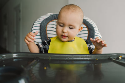 Little child with solid nutrition. baby girl eating food and mix vegetable plate