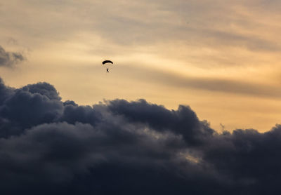 Low angle view of parachute flying in sky