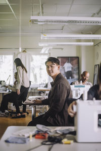 Side view portrait of male design professional sitting at workshop