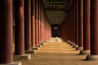 Man walking in corridor of building