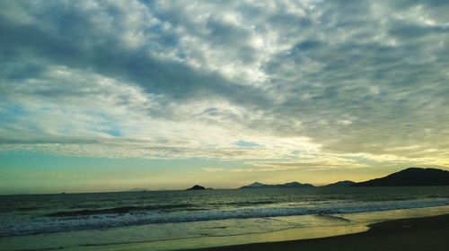 Scenic view of beach against sky during sunset