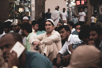 Group of people standing on street in city