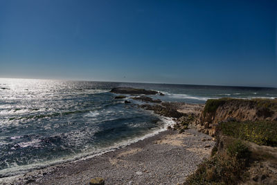 Scenic view of sea against clear blue sky