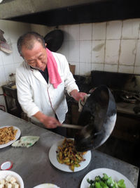 High angle view of man preparing food in kitchen