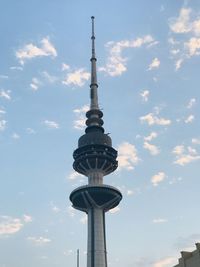 Low angle view of communications tower against sky