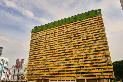 Low angle view of building against cloudy sky