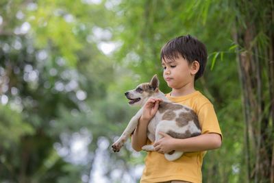 Side view of a boy with dog