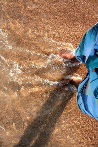 Close-up low section of man in water