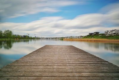 Pier over lake against sky