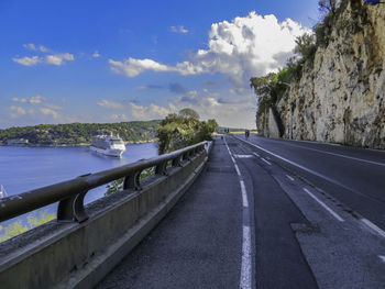 Road by sea against sky