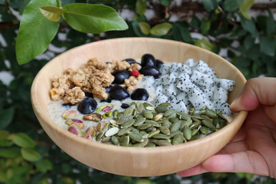 Midsection of person holding bowl