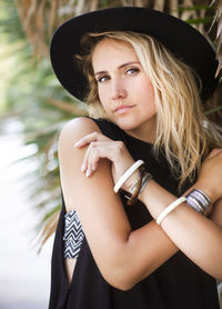 Portrait of beautiful woman wearing hat standing outdoors