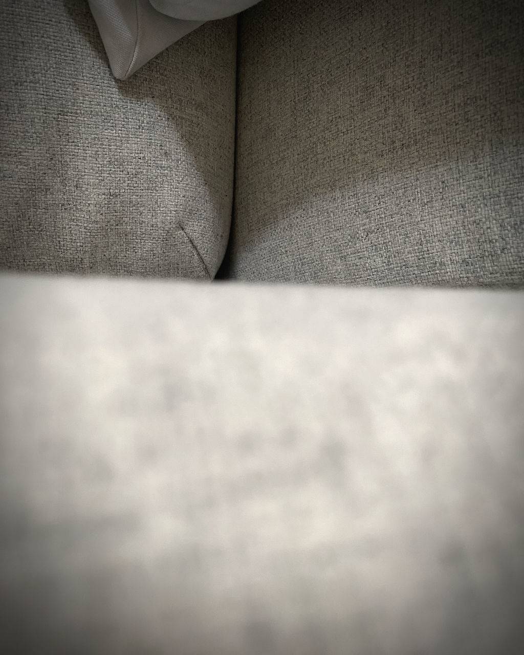 white, black, indoors, close-up, black and white, monochrome, no people, textile, sofa, vignette, light, furniture, selective focus, monochrome photography, textured, darkness, arm