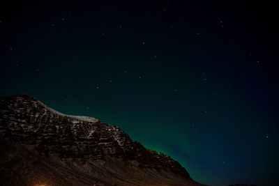 Low angle view of mountain against sky at night