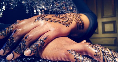 Close-up of mehendi pattern on hands