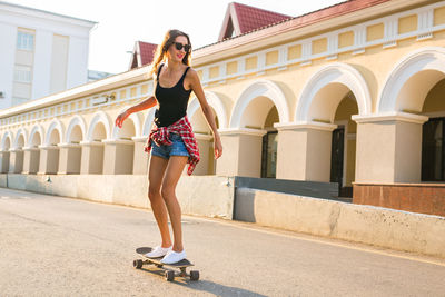 Woman skateboarding outdoors