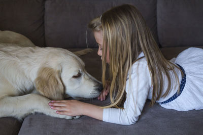 Girl with dog at home