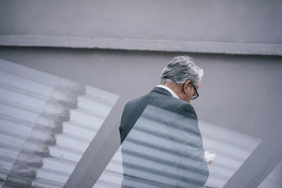 Rear viewof senior businessman using tablet