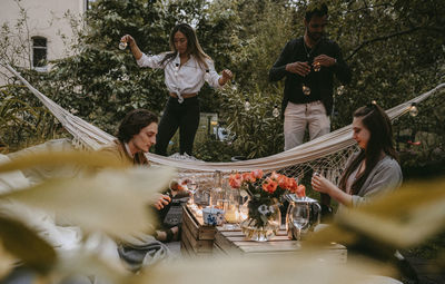 Group of people sitting on table against trees