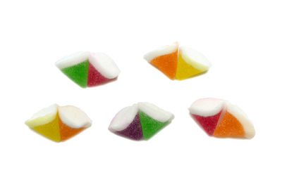 Close-up of multi colored candies against white background