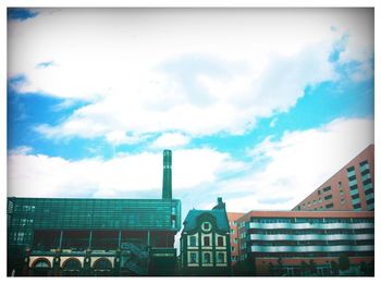 Low angle view of building against cloudy sky