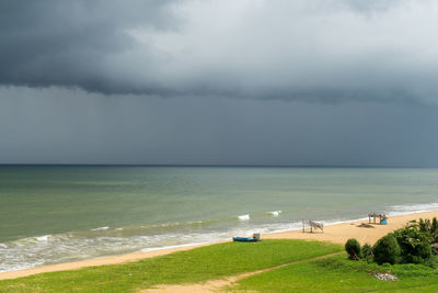 Beach before storm. negombo, sri lanka . cloudy and dramatic sky. sunlight on beach