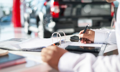 Midsection of businessman working at table