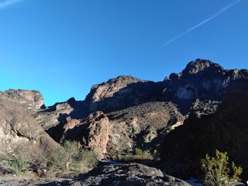 Scenic view of rocky mountains against clear blue sky