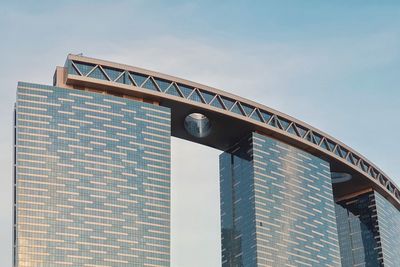 Low angle view of bridge and building against sky