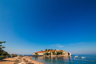 View of sea against clear blue sky