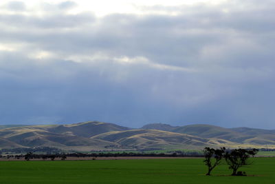 Scenic view of landscape against cloudy sky