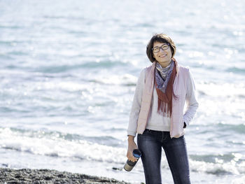 Full length portrait of woman standing on beach