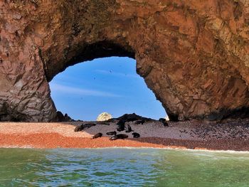 Scenic view of sea seen through cave