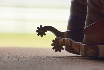 Close-up of spurs on cowboy boots