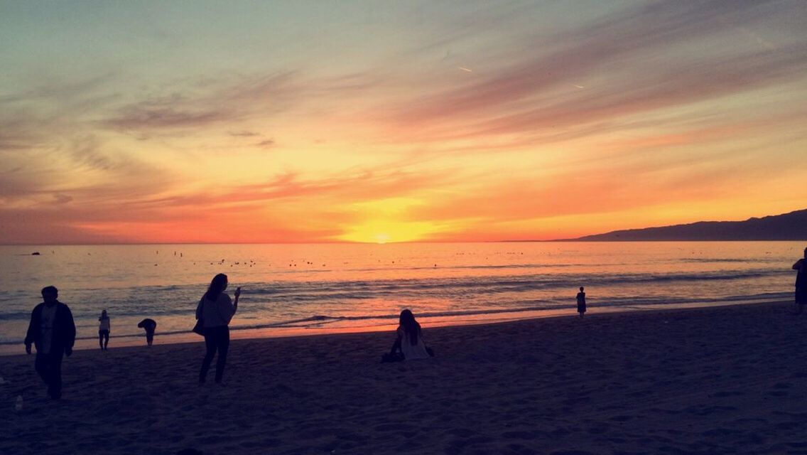 sunset, beach, sea, sand, nature, beauty in nature, water, scenics, shore, silhouette, orange color, sky, horizon over water, vacations, leisure activity, outdoors, tranquil scene, enjoyment, tranquility, real people, lifestyles, summer, full length, togetherness, men, beach volleyball, day, people