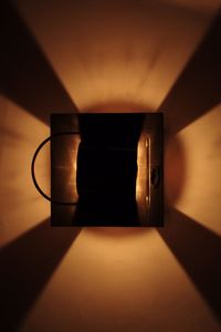 Close-up of illuminated lamp on table