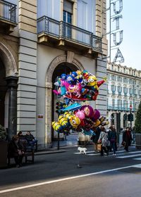 Balloons at street for sale against buildings