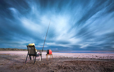 Rear view of man on beach against sky