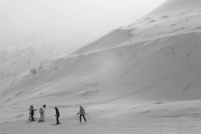 People walking on snow covered land