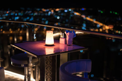Close-up of illuminated candles on table in restaurant