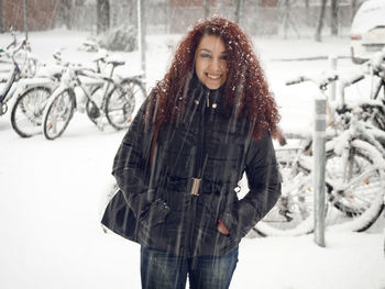 Portrait of beautiful woman during snowfall